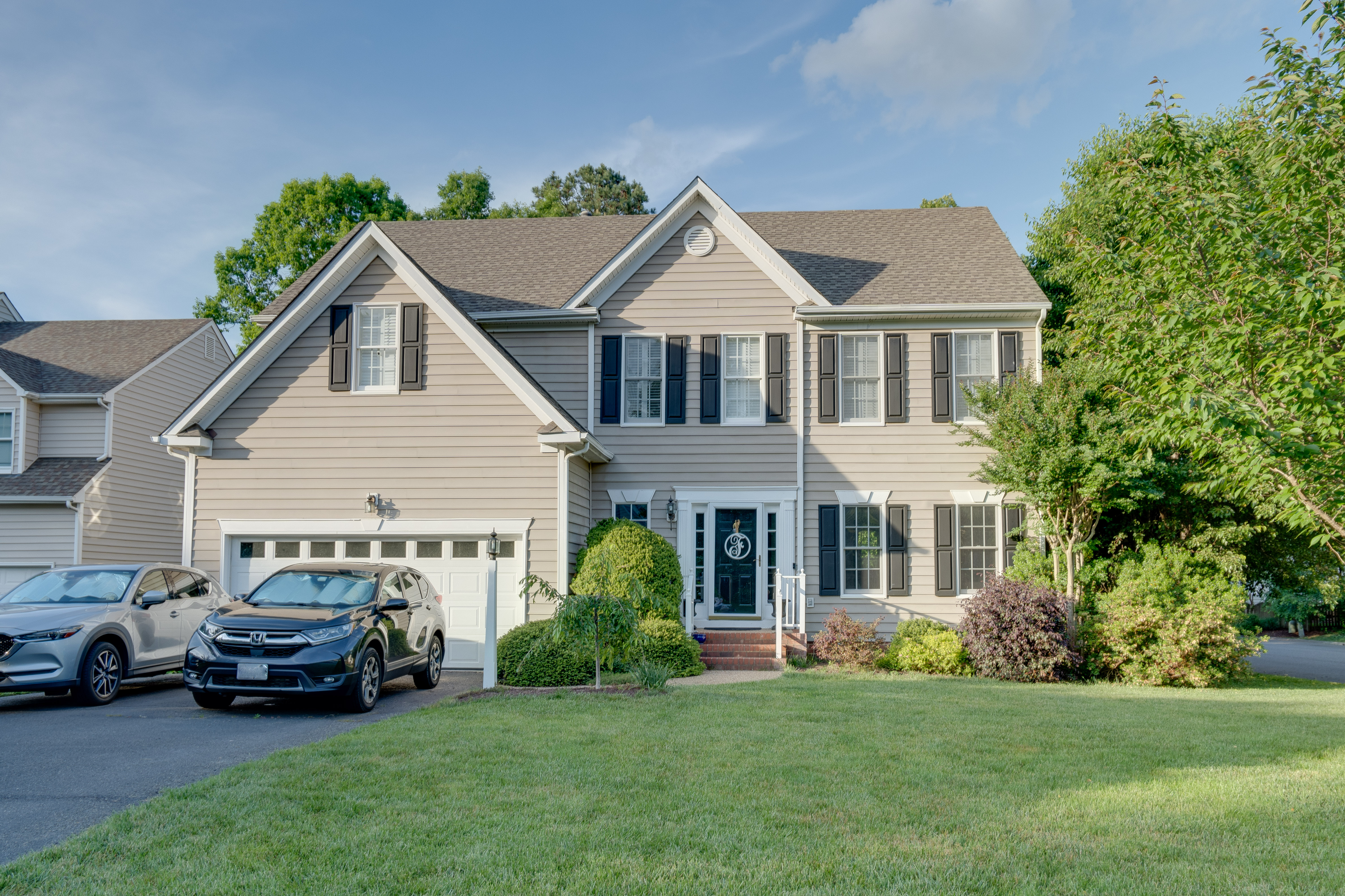 Colonial-style home with manicured lawn