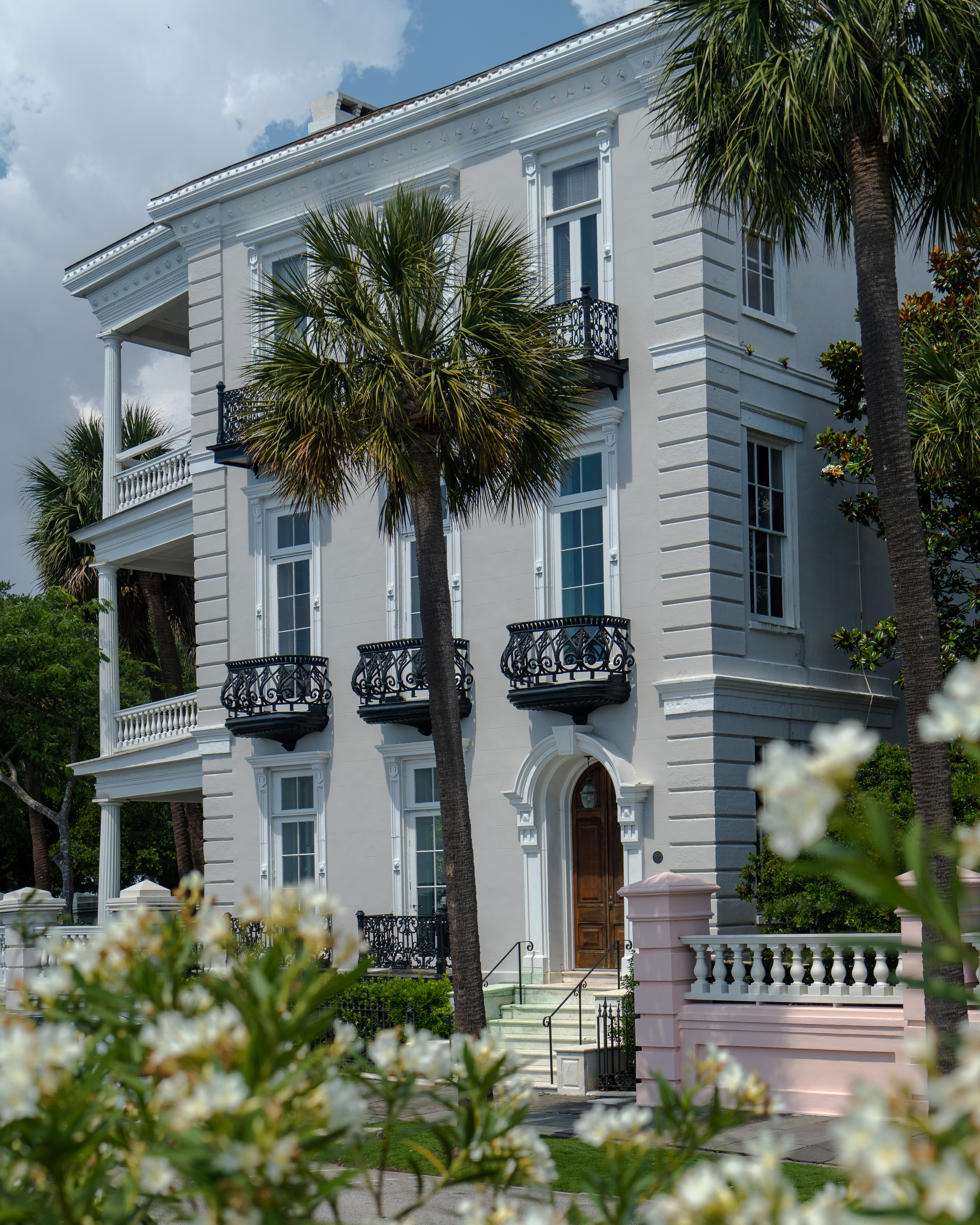 Grand neoclassical estate with palm trees