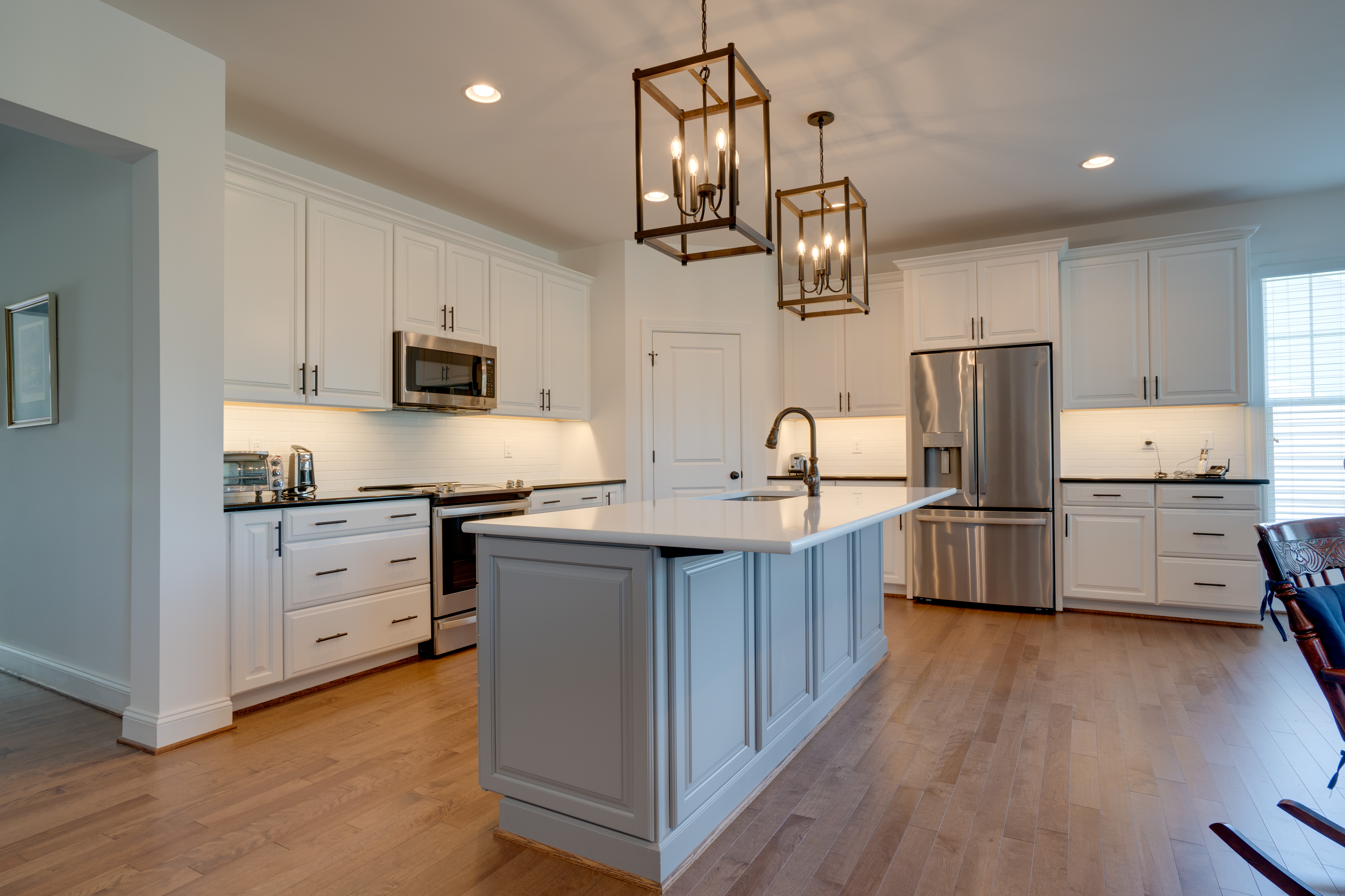 Modern white kitchen with pendant lights